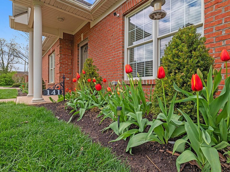 upclose look of the home & landscape beautiful tulips lining the house right up to the entryway of the house.