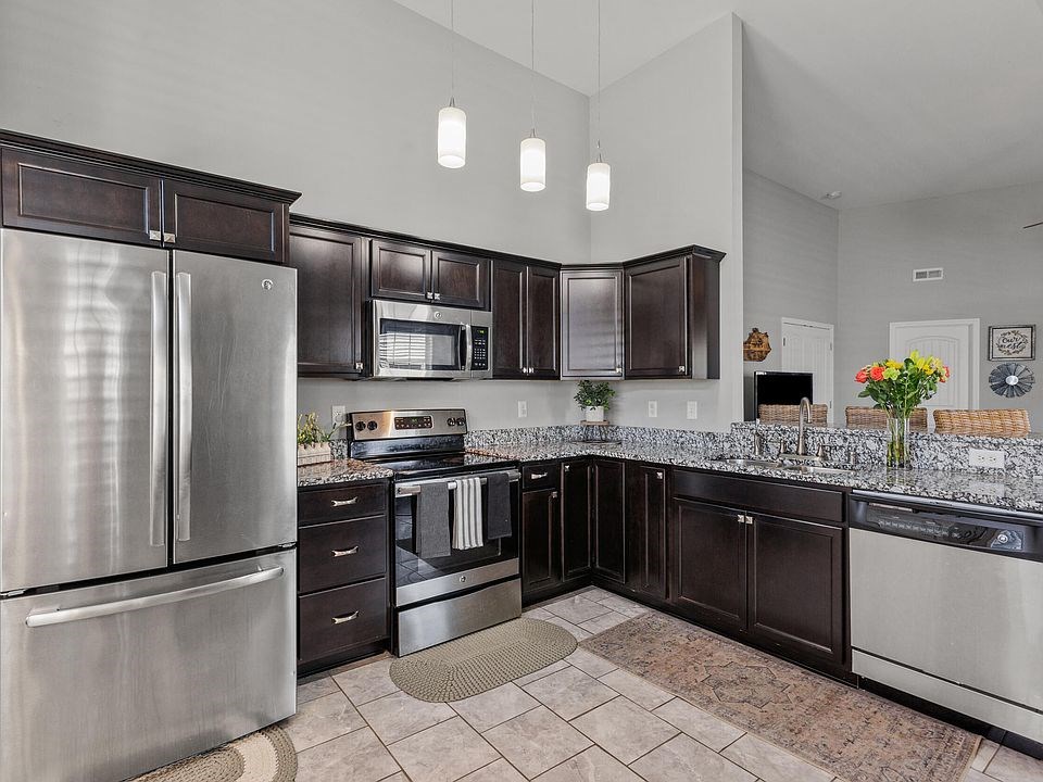 spacious kitchen! this is great for those who like to be in the kitchen! there's tile flooring and l-shaped cabinets with a fridge, oven & microwave, and dish washer all provided.